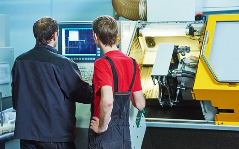 Two technician looking at a screen