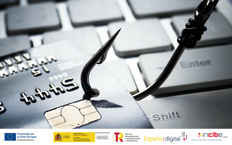 Portada blog Principales formas de estafa a través del email: phishing más comunes tarjeta atravesada con un arpón sobre un teclado